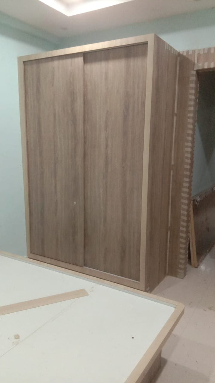 Two-door sliding wardrobe with natural wood grain finish