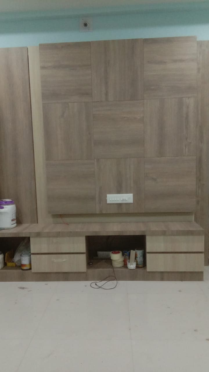 Grid pattern wooden TV wall paneling with bottom storage drawers