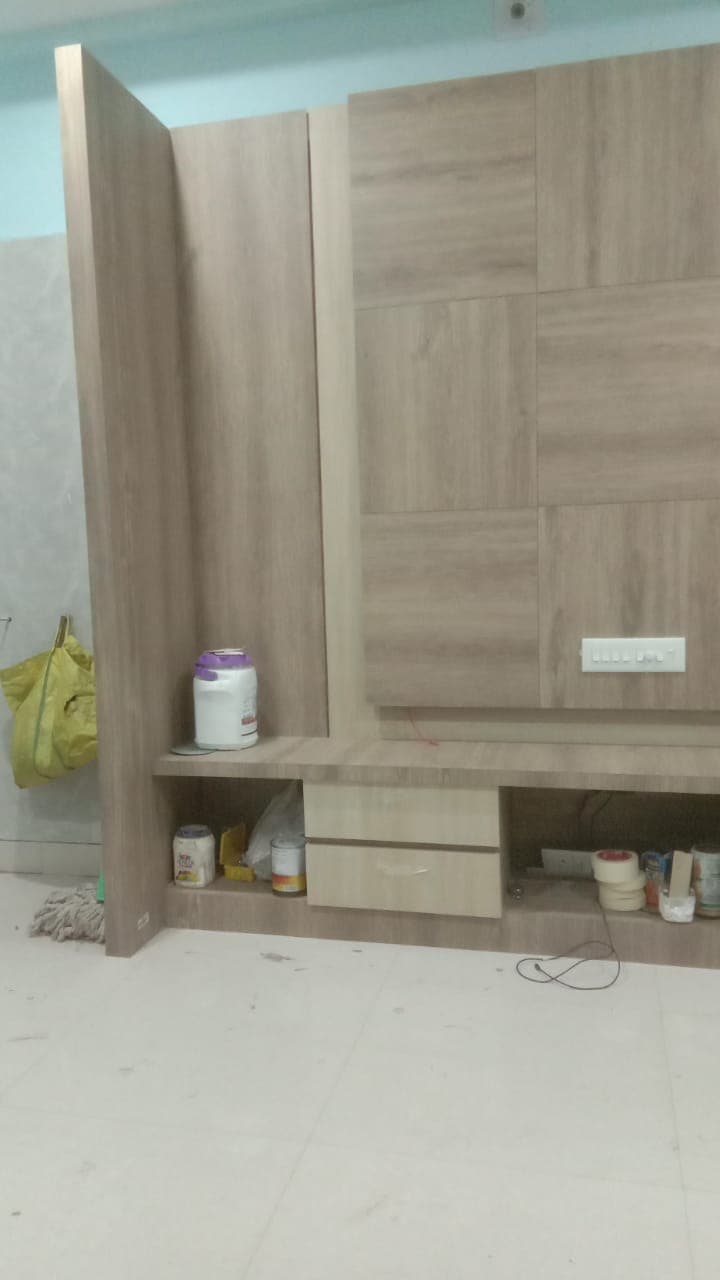 Custom entertainment wall unit under precision carpentry execution